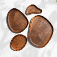 Four contorted walnut wood serving trays in different sizes, top view