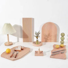 Collection of grooved light wood decor trays with lamp and vases