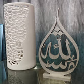 Teardrop shaped Mashaallah calligraphy table decor beside white vase