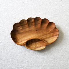Empty scalloped paw shaped wooden serving tray with small compartment, top view