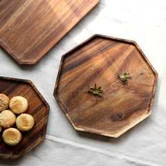 Octagon wooden serving trays with cookies and nuts on white cloth