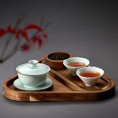 Triangle wooden platter tray serving green tea set on dark background