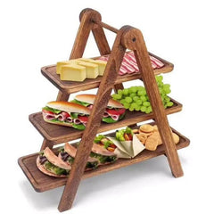 A-frame three-tier serving tray rack loaded with sandwiches, cheese and grapes on white