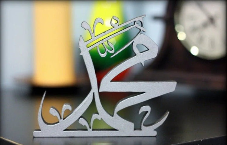 Close-up of white Muhammad Arabic calligraphy table decor piece