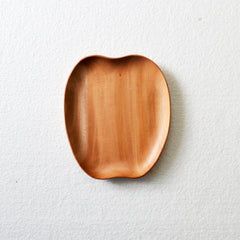 Empty apple shaped wooden serving tray on white surface, top view