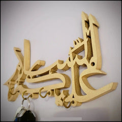 Angled side view of gold Assalamualaikum calligraphy key holder with keys