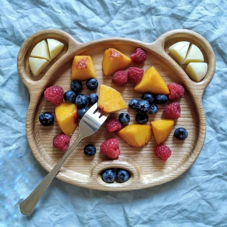 Bear shaped wooden kids platter filled with berries, mango and egg slices
