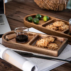 Wave oval wooden trays with limes, cookies and glass cup on dark table