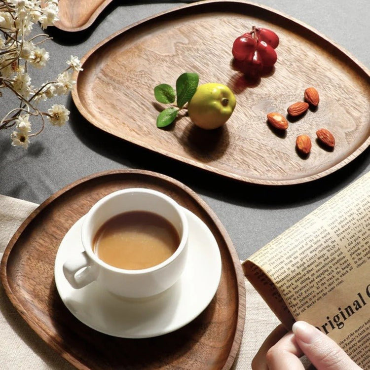 Irregular wooden serving trays with coffee cup, grapes and almonds