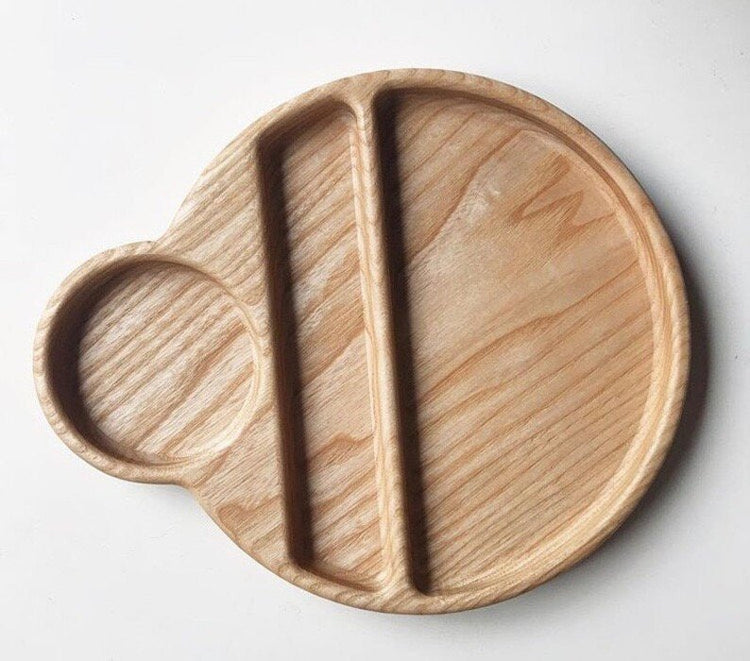 Empty round wooden food tray with cup holder and spoon groove, top view