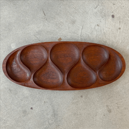 Top view of dark teak wood oval serving tray with five sections