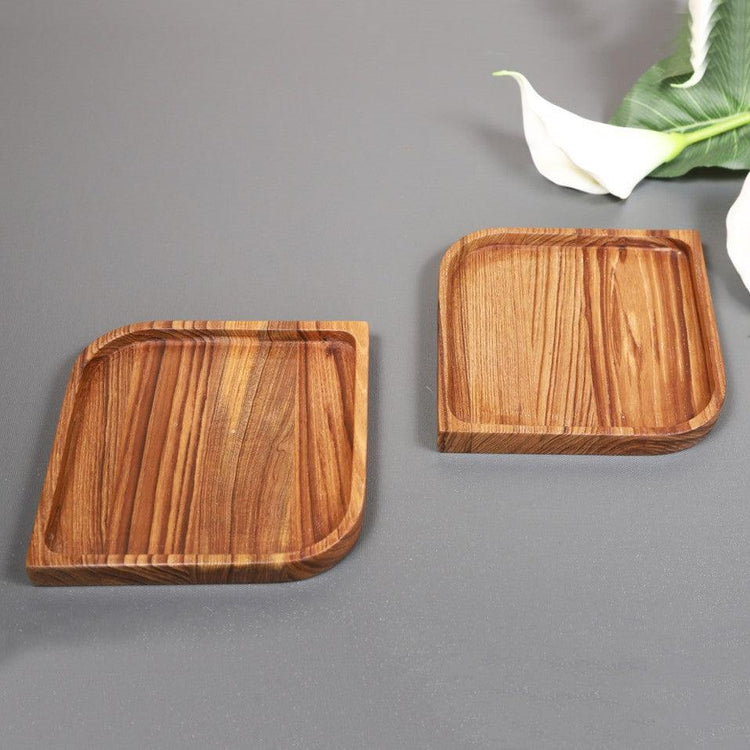 Two solid wood serving coaster trays with rounded corners on grey background