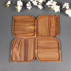 Set of four square wood serving platters arranged together, top view