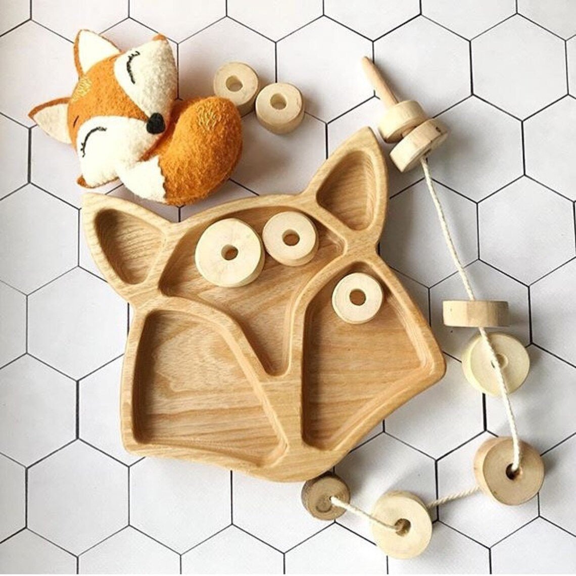 Fox shape wooden kids platter with toy fox and wooden beads on white tiles