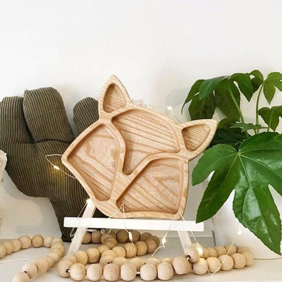 Fox wooden kids platter standing upright with wooden bead garland and plant