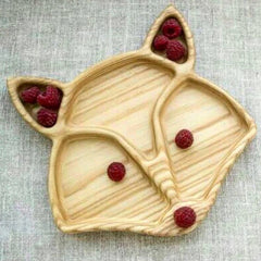 Light wood fox face serving tray with raspberries in sections, top view