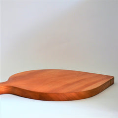 Side view of leaf shaped wooden serving board showing thickness
