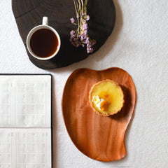 Mango shape wooden platter tray serving tart beside cup of coffee