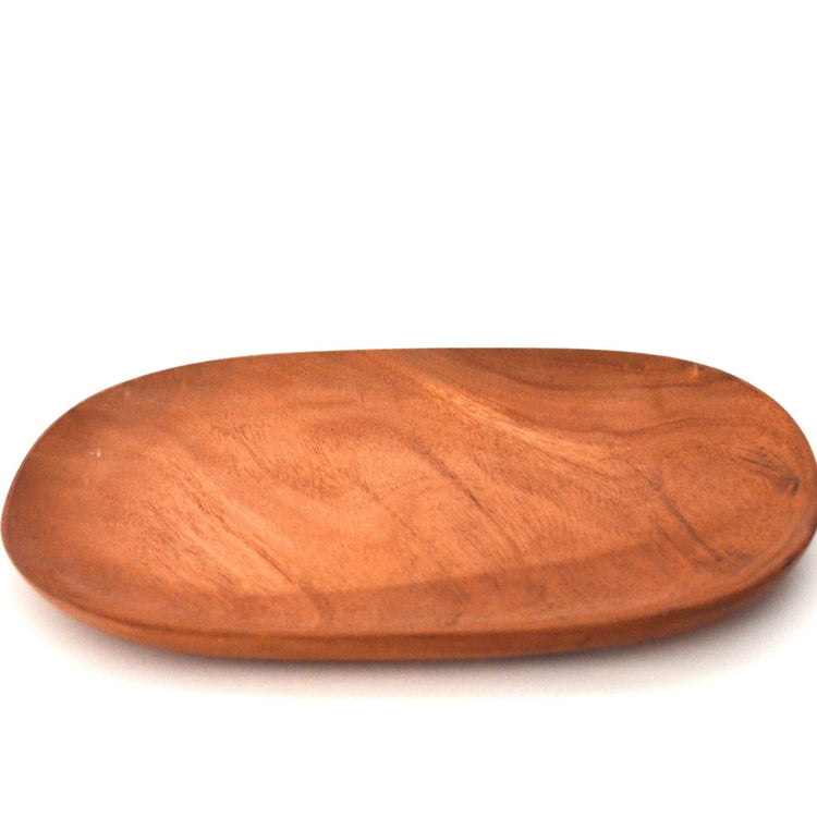 Empty oval shape wooden serving platter, angled view on white background