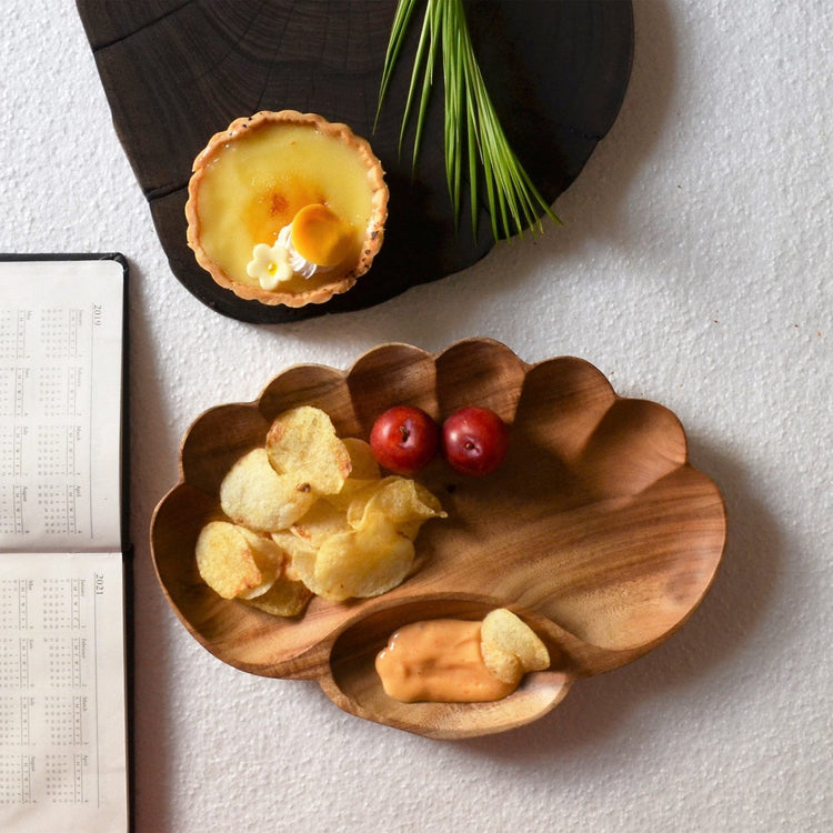 Paw shape wooden platter with fruit slices and compartments beside tart