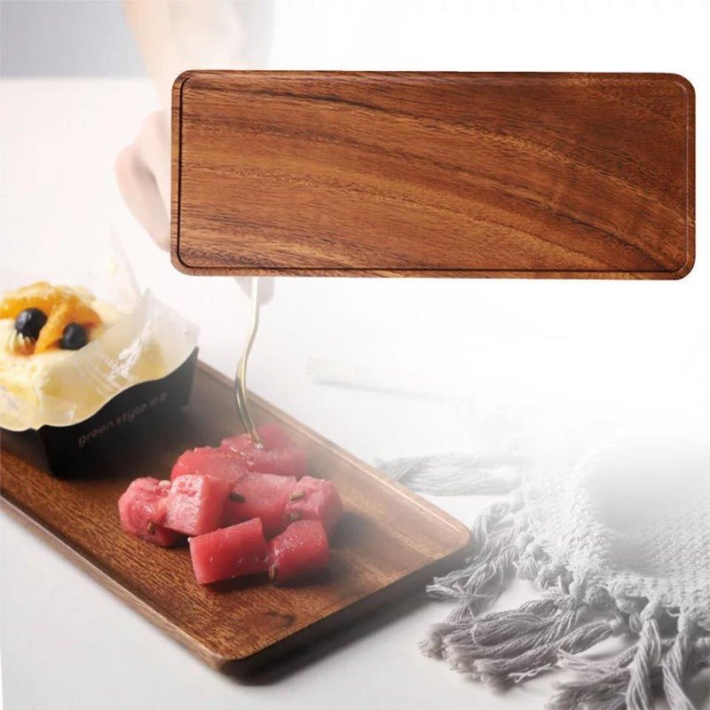 Rectangular wooden tea tray shown above tray serving sweets on table