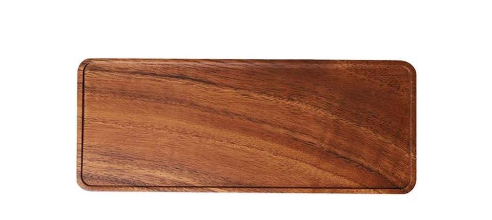 Long rectangular wooden serving tray with rounded corners, top view on white