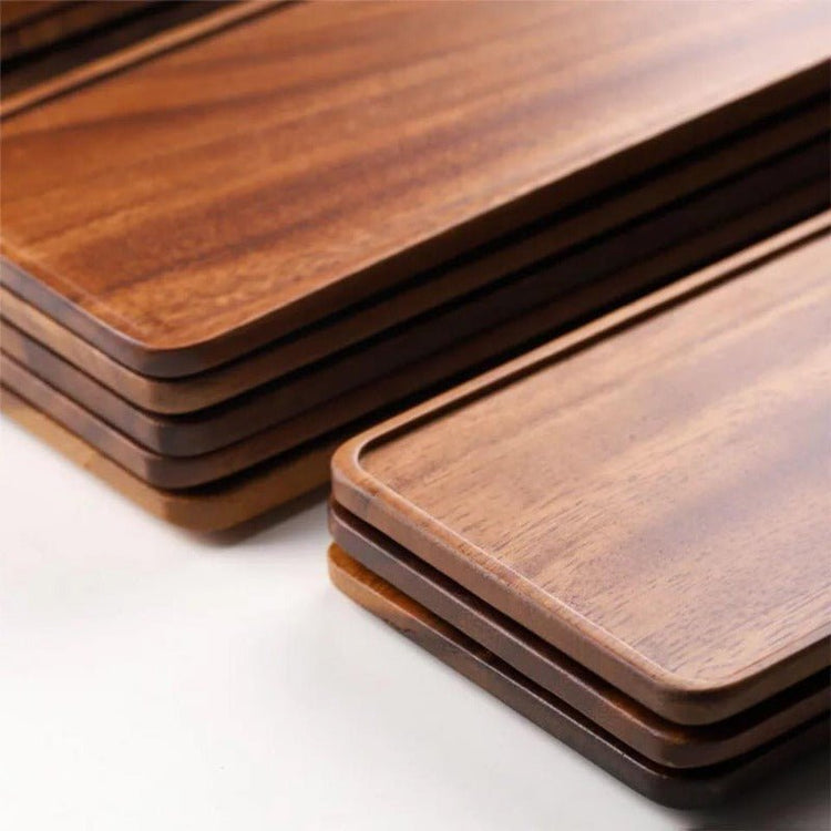 Close-up of stacked wooden tea trays showing raised edges and wood grain