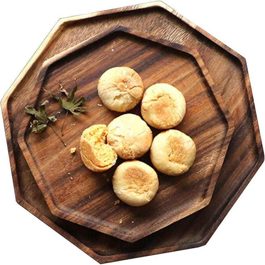 Two stacked octagon wooden serving trays with round pastries