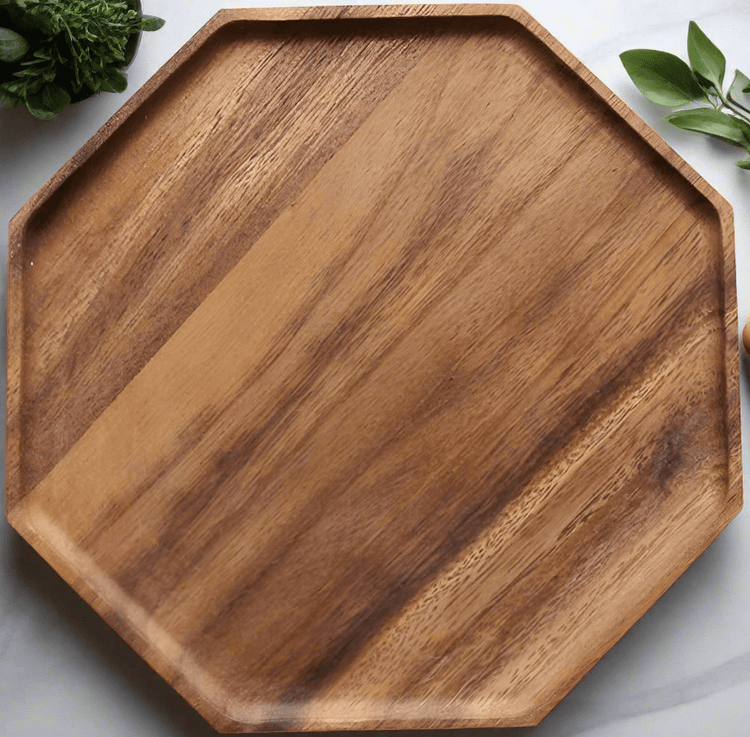 Close-up of octagon wooden platter edge with green leaves