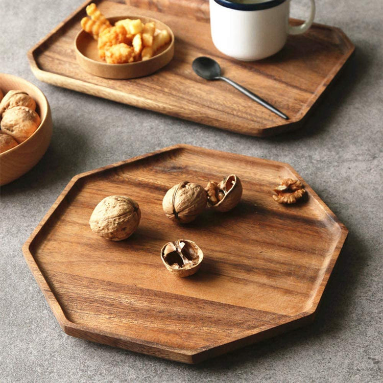 Octagon wooden platters holding walnuts and snacks beside coffee cup