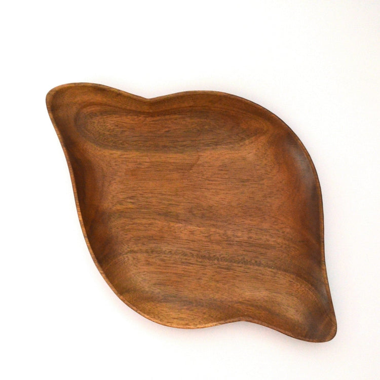 Empty shell shaped wooden serving tray with wood grain, top view
