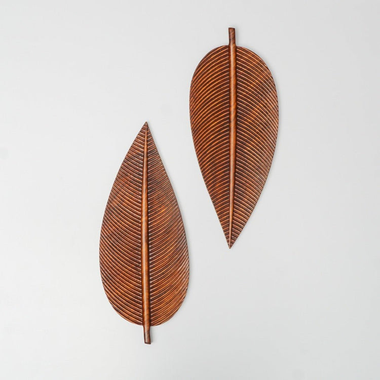 Two carved wooden leaf trays in small and large sizes placed upright