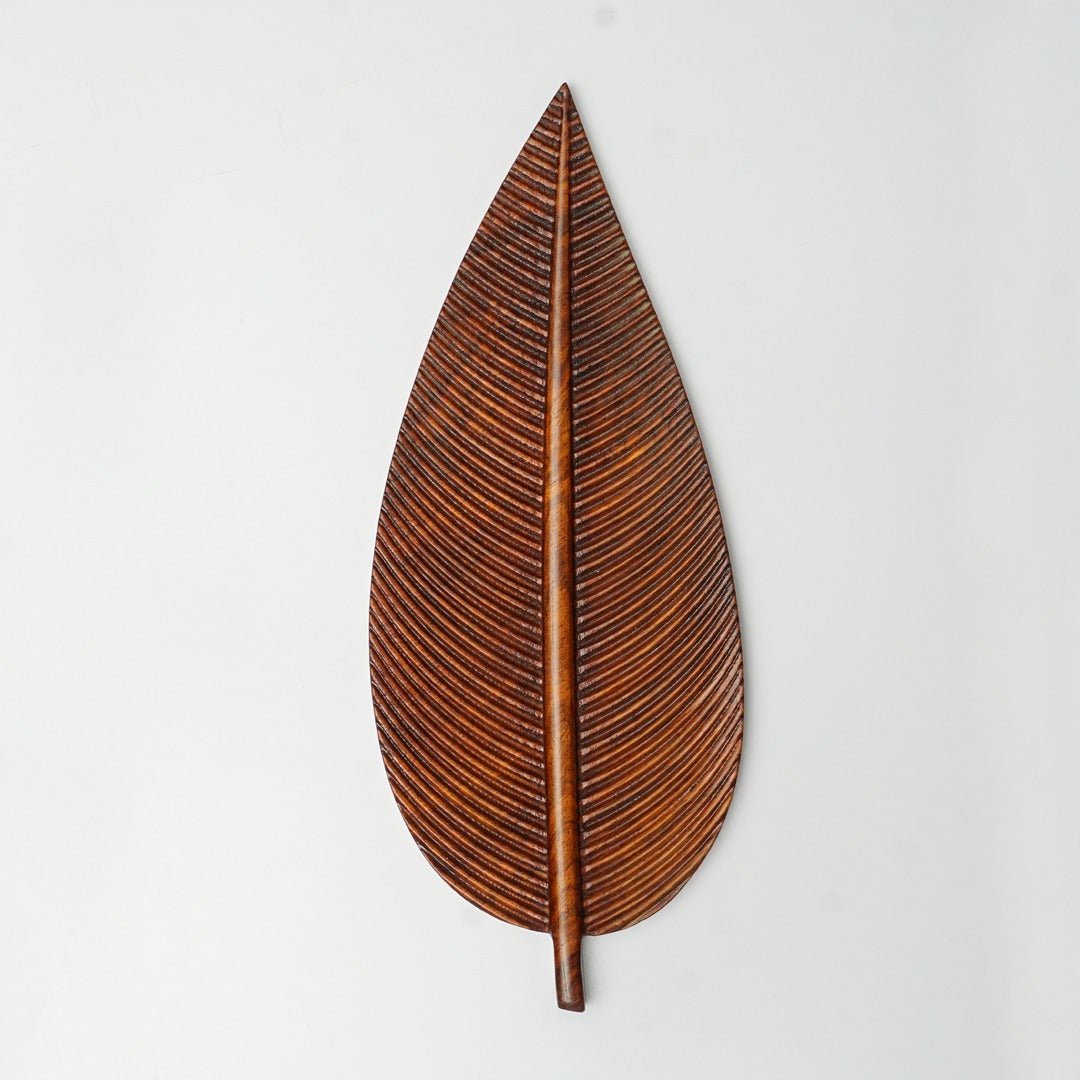 Single brown wooden leaf serving tray with carved ridges, top view
