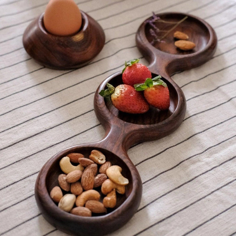 Triple round dry fruit wooden platter with strawberries, nuts and egg