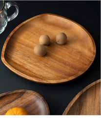 Close-up of rounded triangular wooden platter with two wooden balls