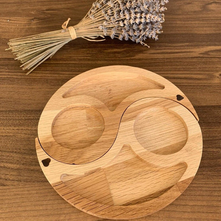 Round light wood yin yang serving tray with dried lavender beside it