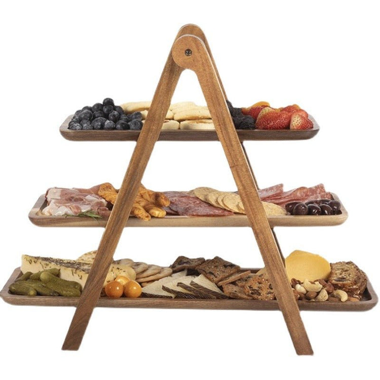 Front view of three-tier wooden serving tray stand filled with charcuterie and fruit